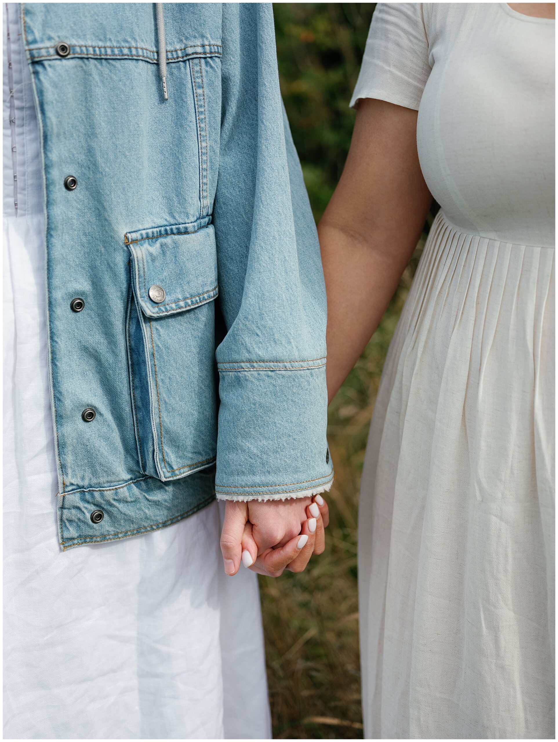 Close-up of Carli and Erin holding hands.