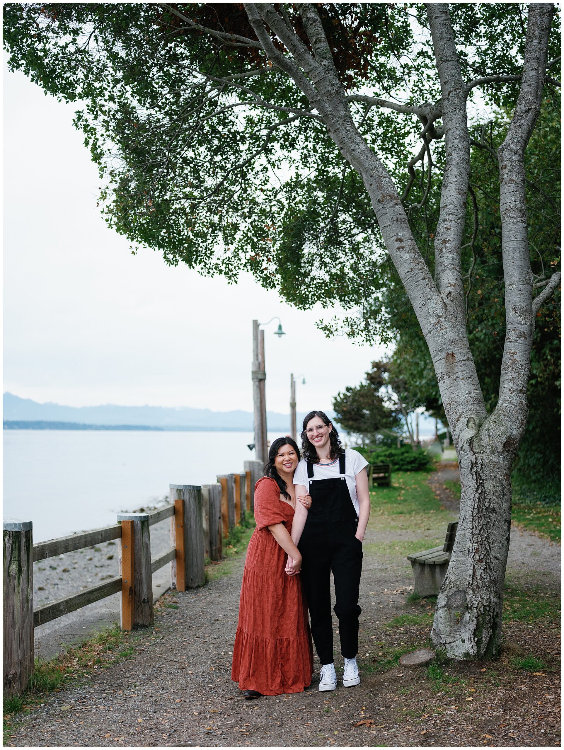 Couple hugging with the ocean in the background