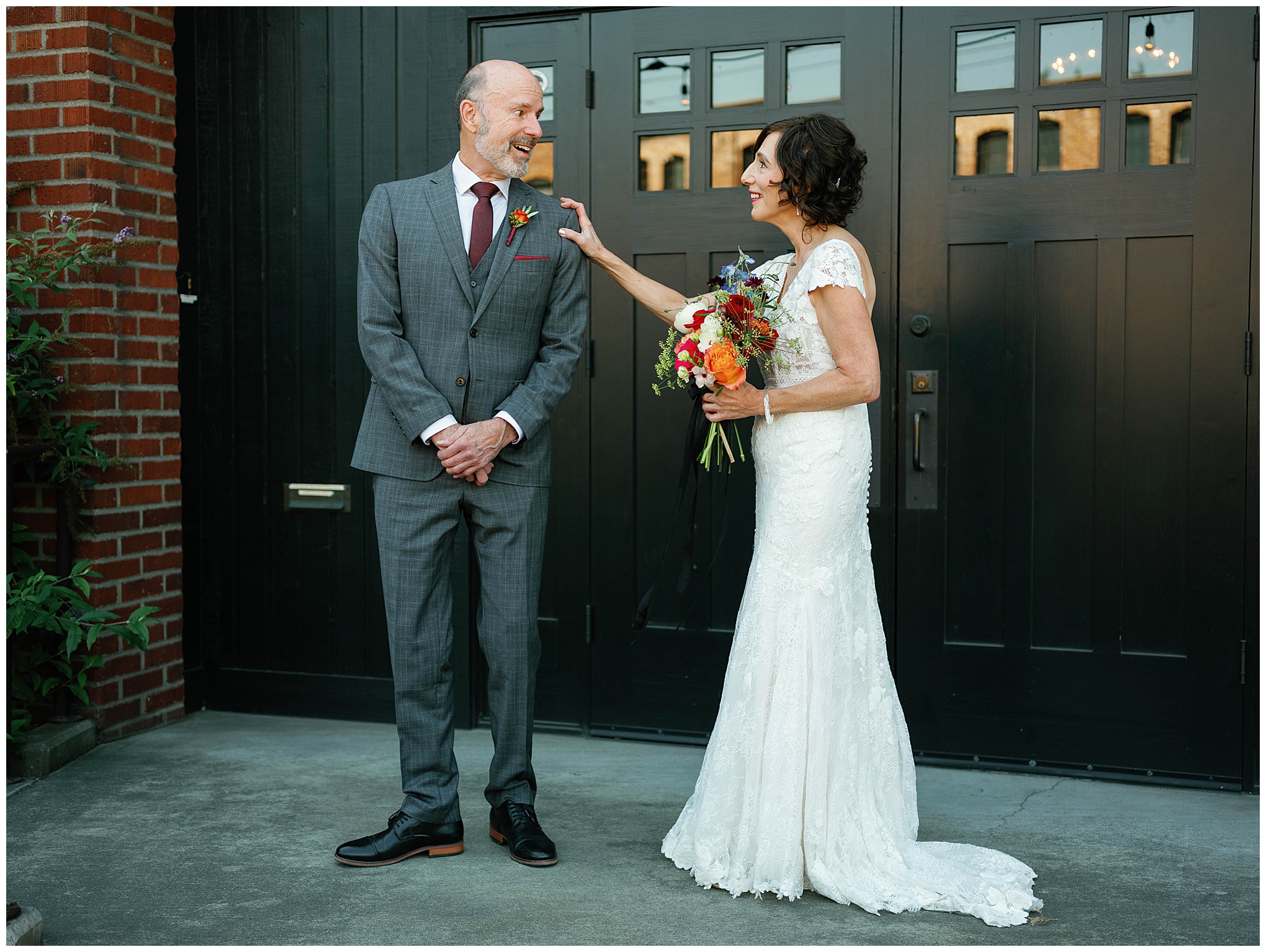 Bride and groom smiling during their first look at Georgetown Ballroom.