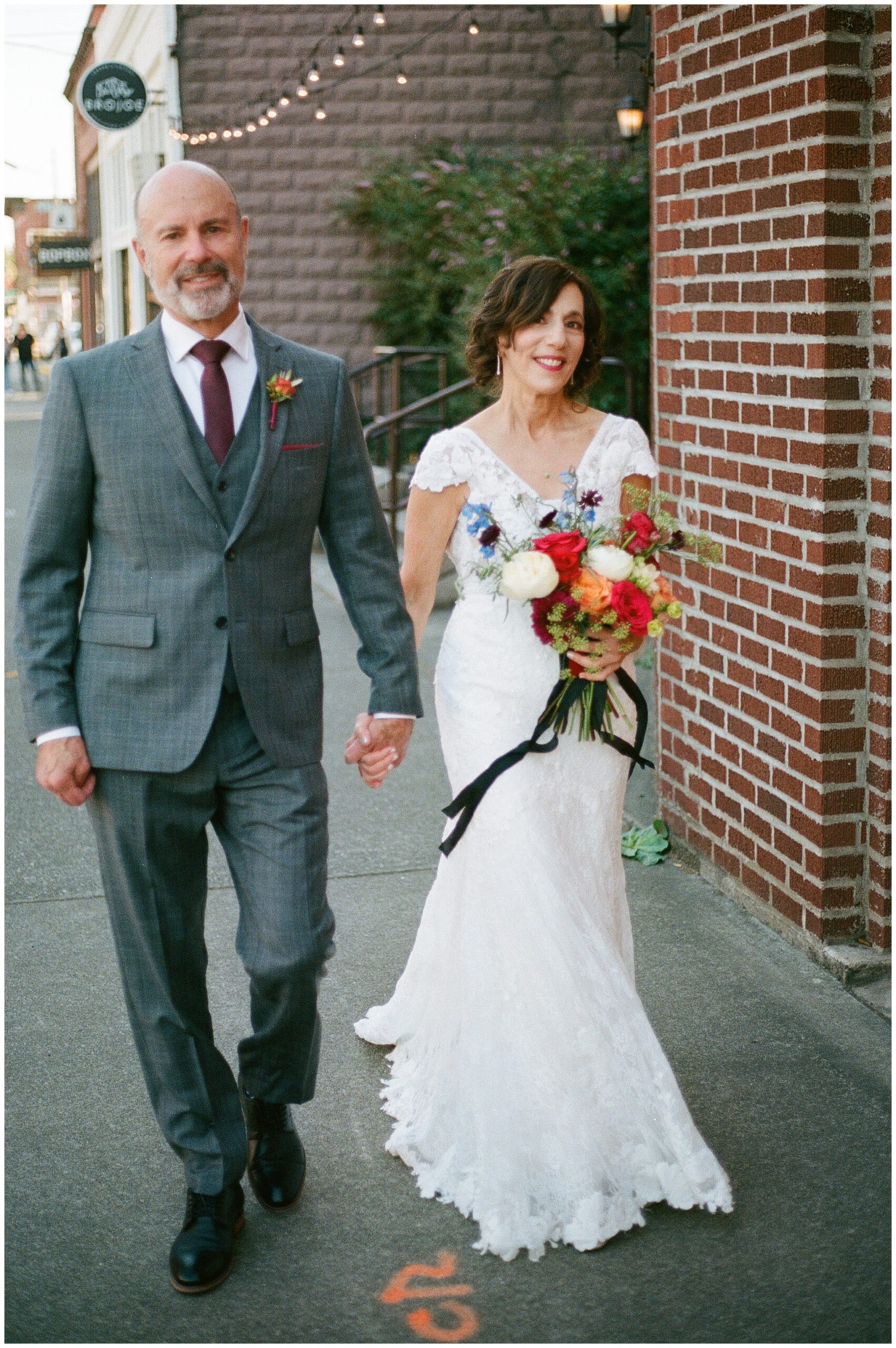 Bride and groom walking hand in hand in Georgetown neighborhood.