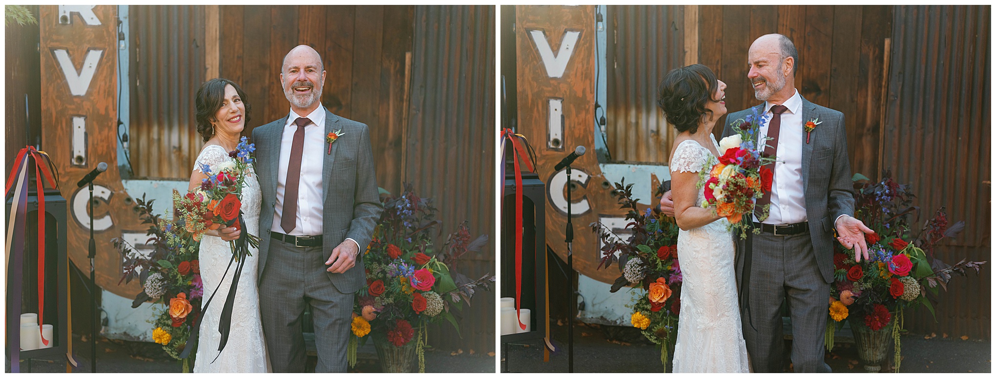 Bride and groom smiling in front of floral backdrop.