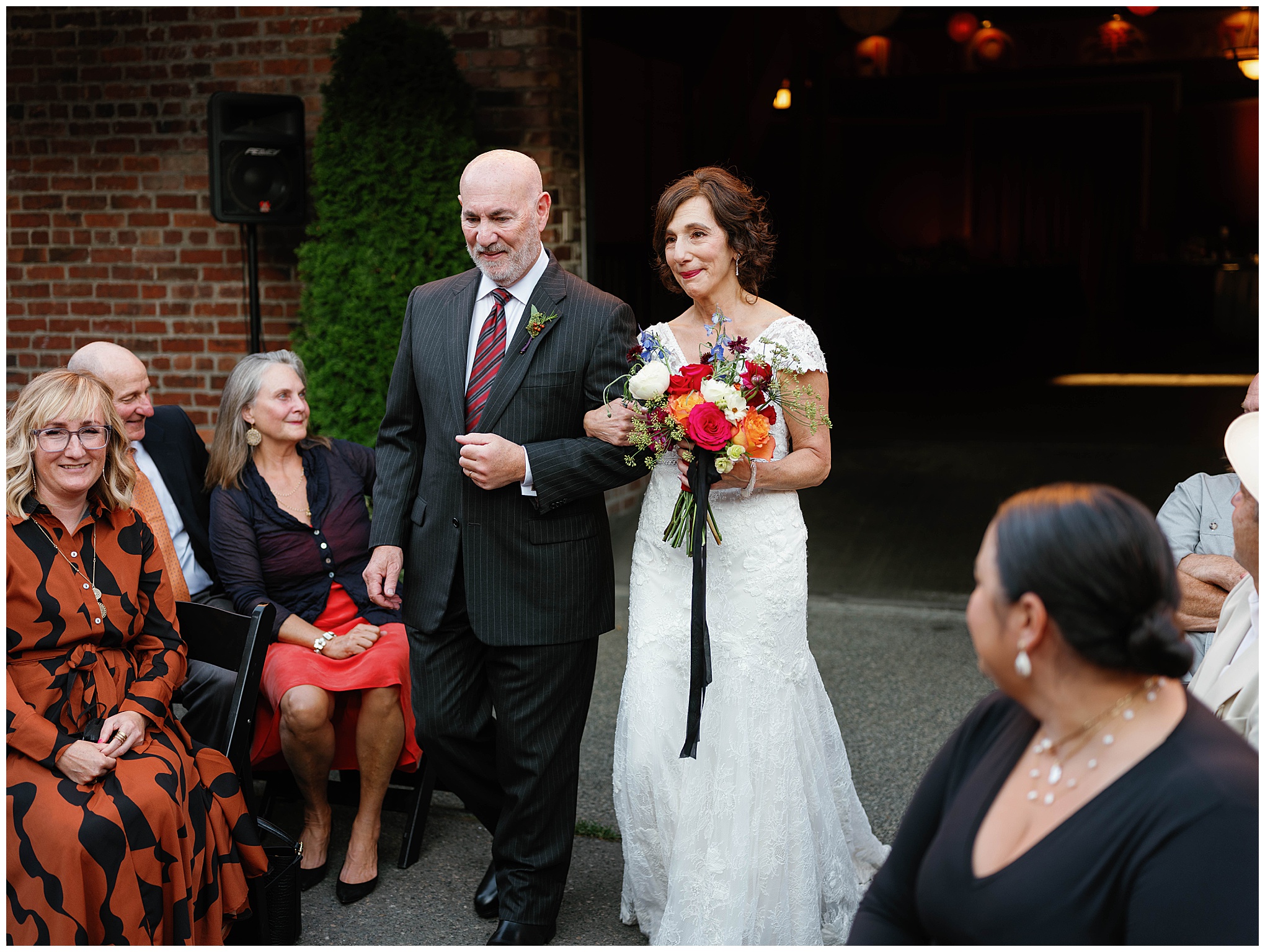 Bride walking down the aisle with a bouquet.