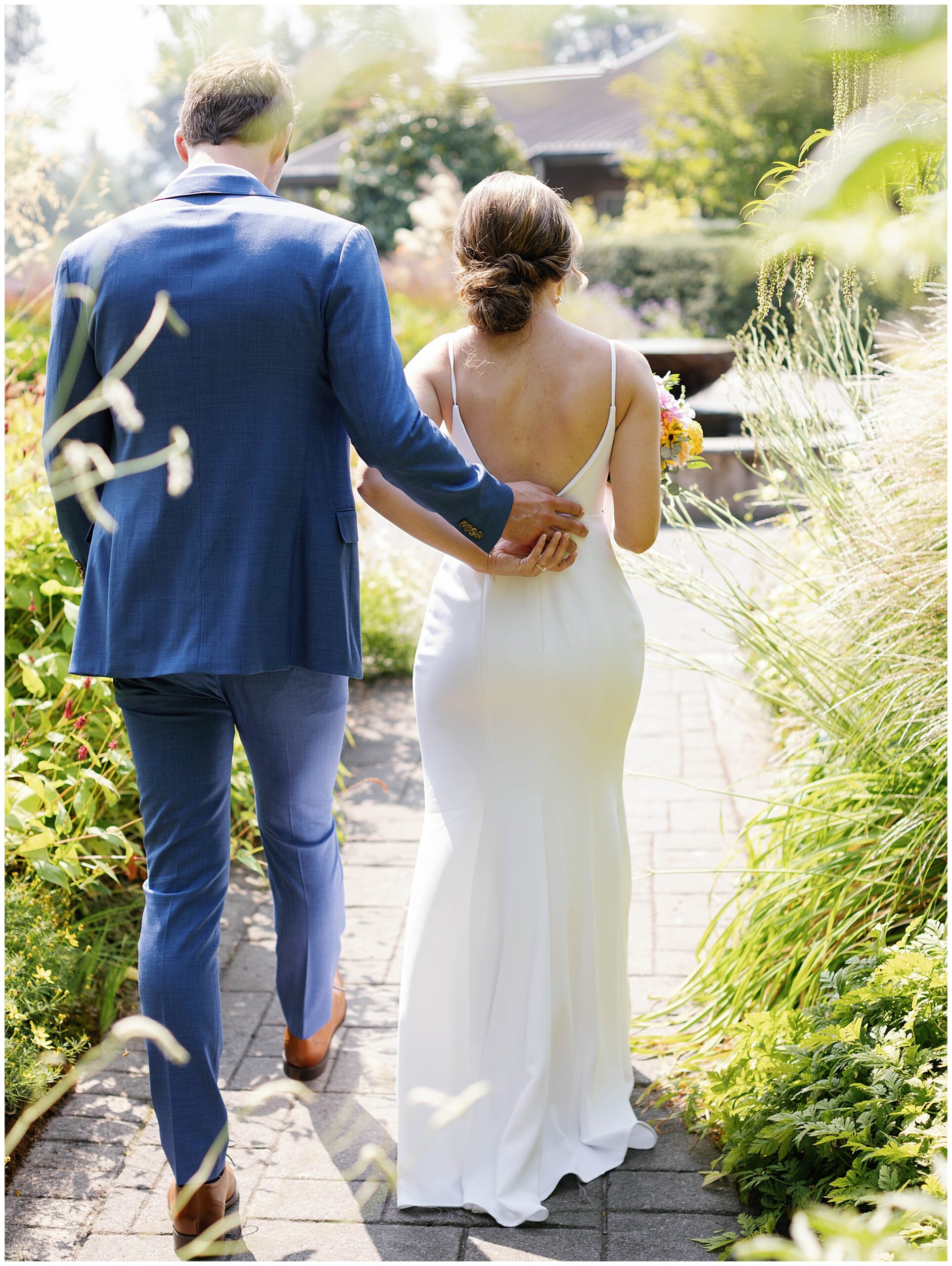 Couple walking away in the garden.