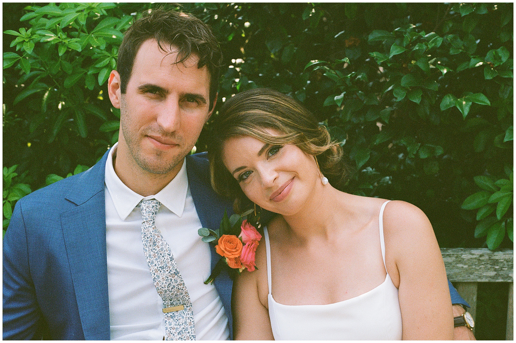 Close-up of the couple smiling while sitting together.