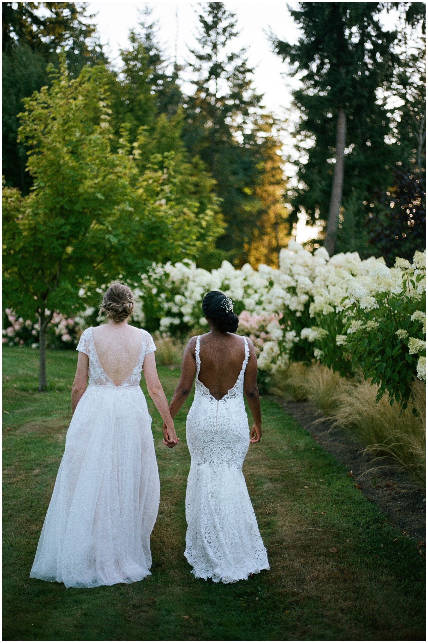 Dannah and Meghan walk hand-in-hand in the garden.