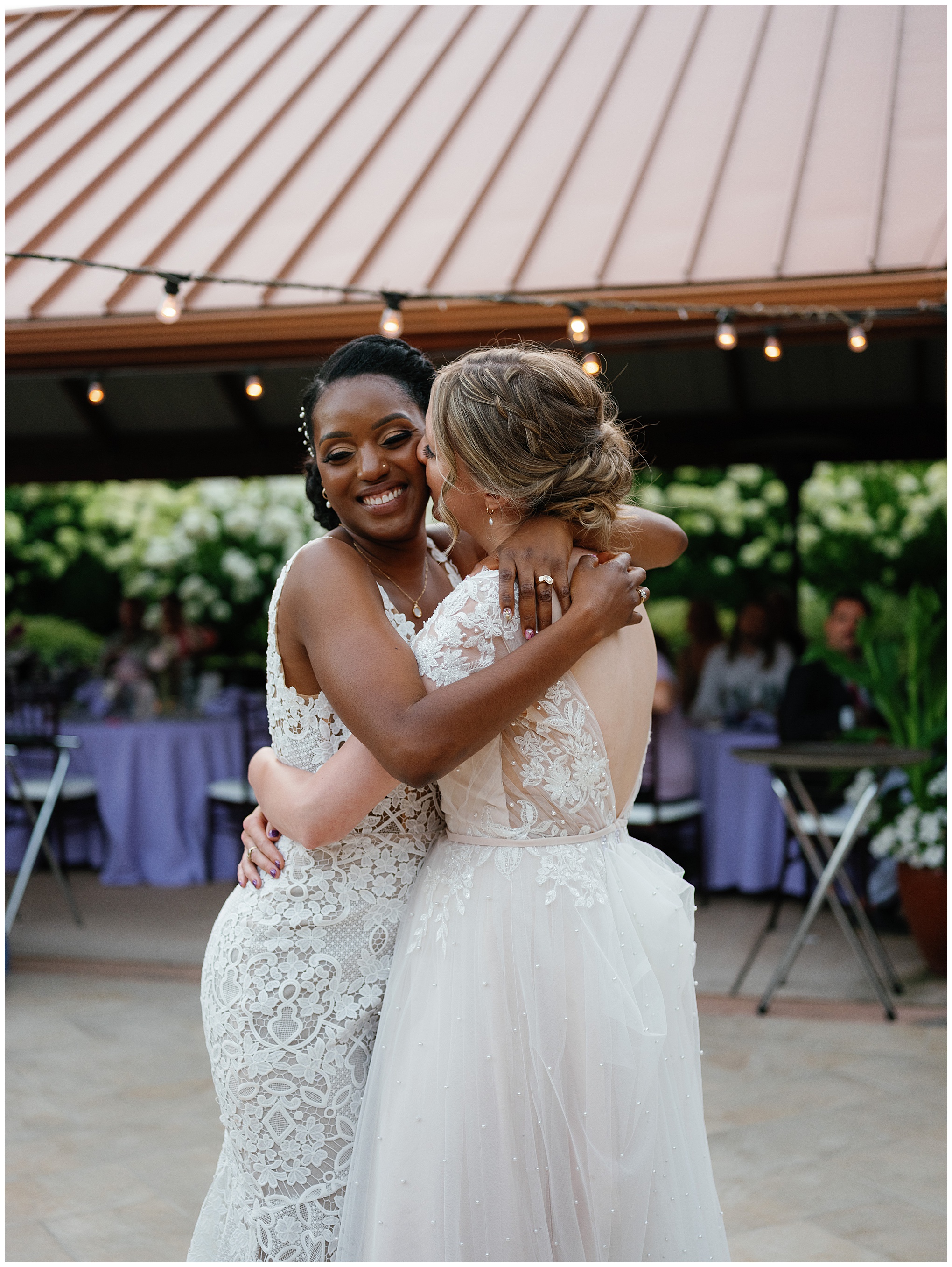 The couple embraces warmly, smiling joyfully during their celebration.