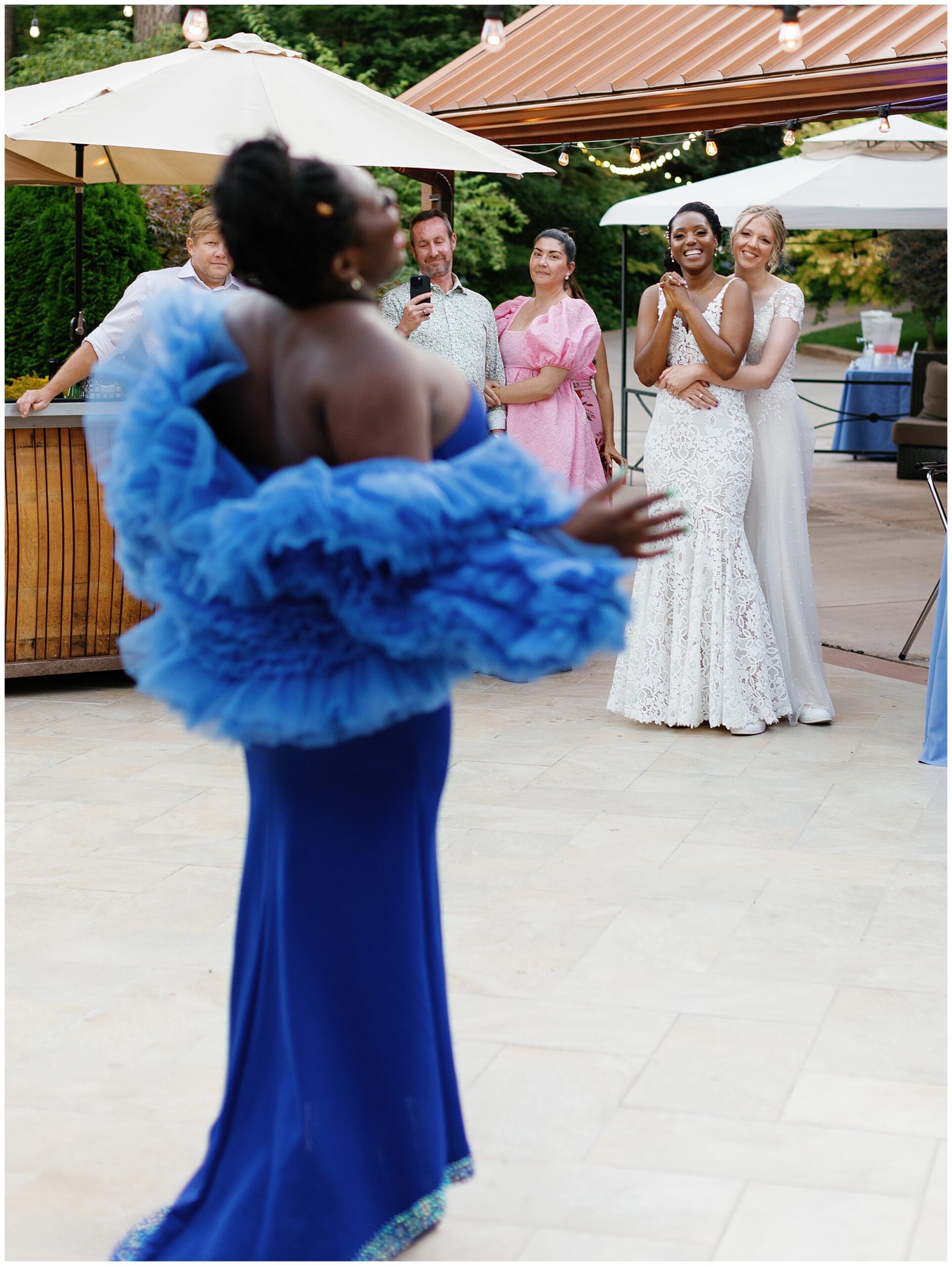 A performer entertains guests in a vibrant blue gown, capturing everyone's attention.