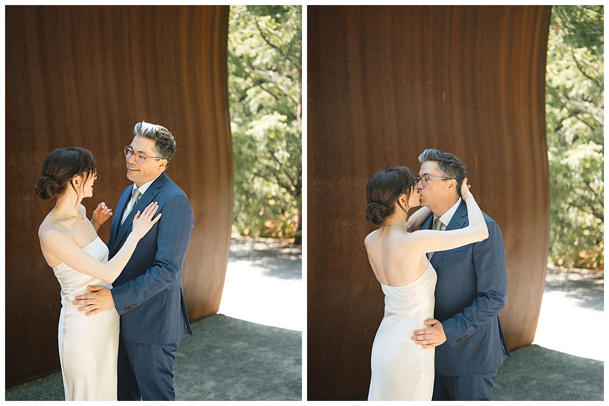 Charlotte and Grant exchanging a kiss during their Seattle wedding at the Olympic Sculpture Garden.