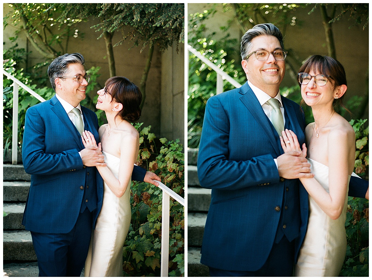 Couple smiling and holding hands on garden steps at the Olympic Sculpture garden for their wedding portraits.