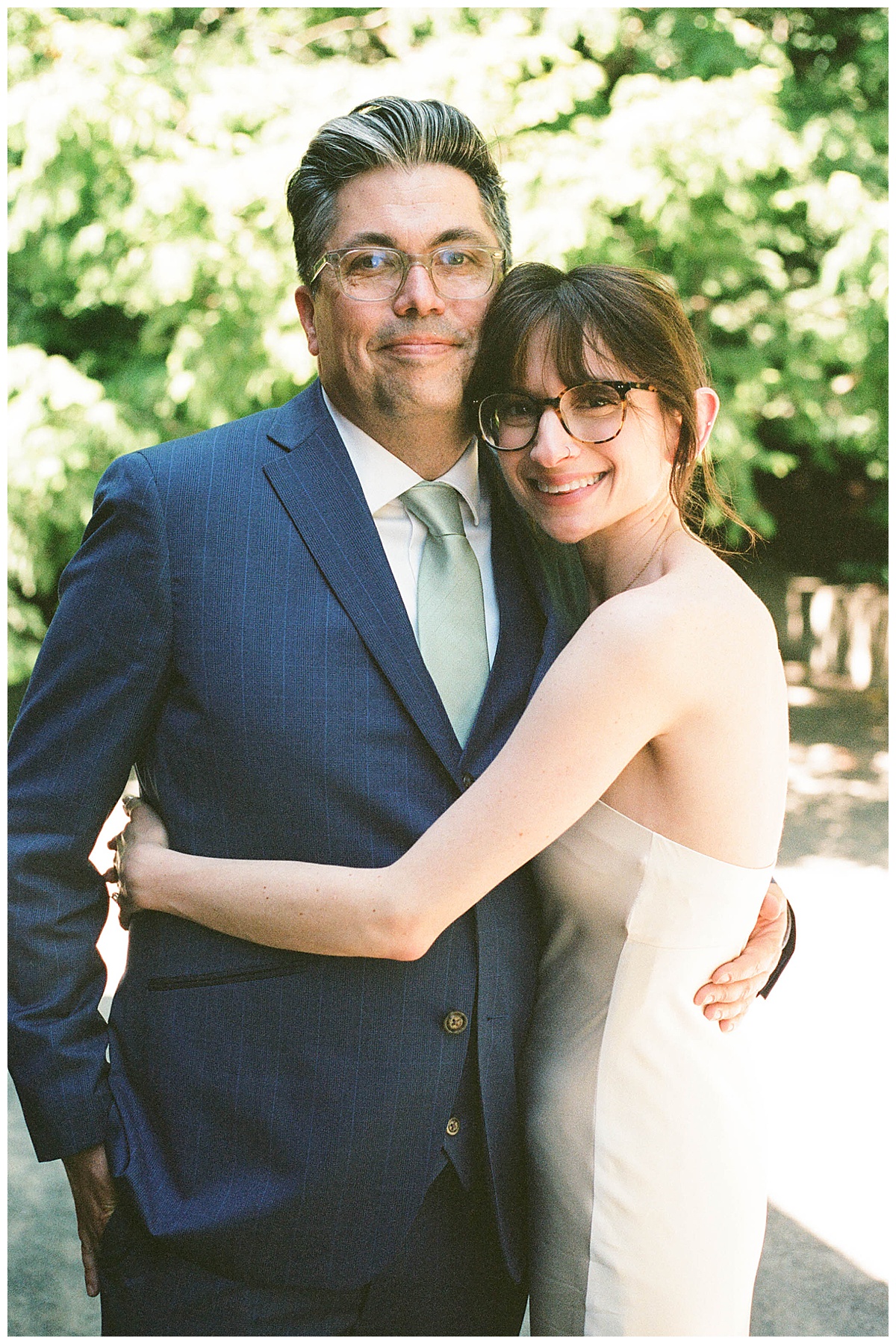 Bride and groom embrace among the greenery at Olympic Sculpture Garden.