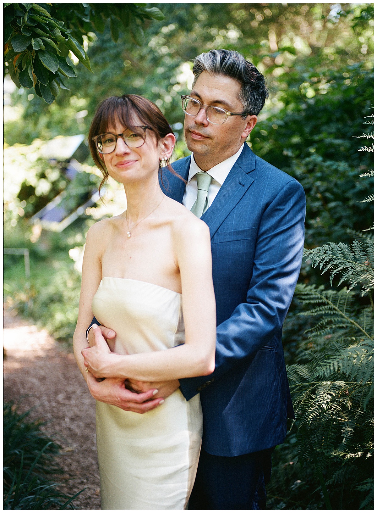 Bride and groom embracing under the trees at Olympic Sculpture Park.