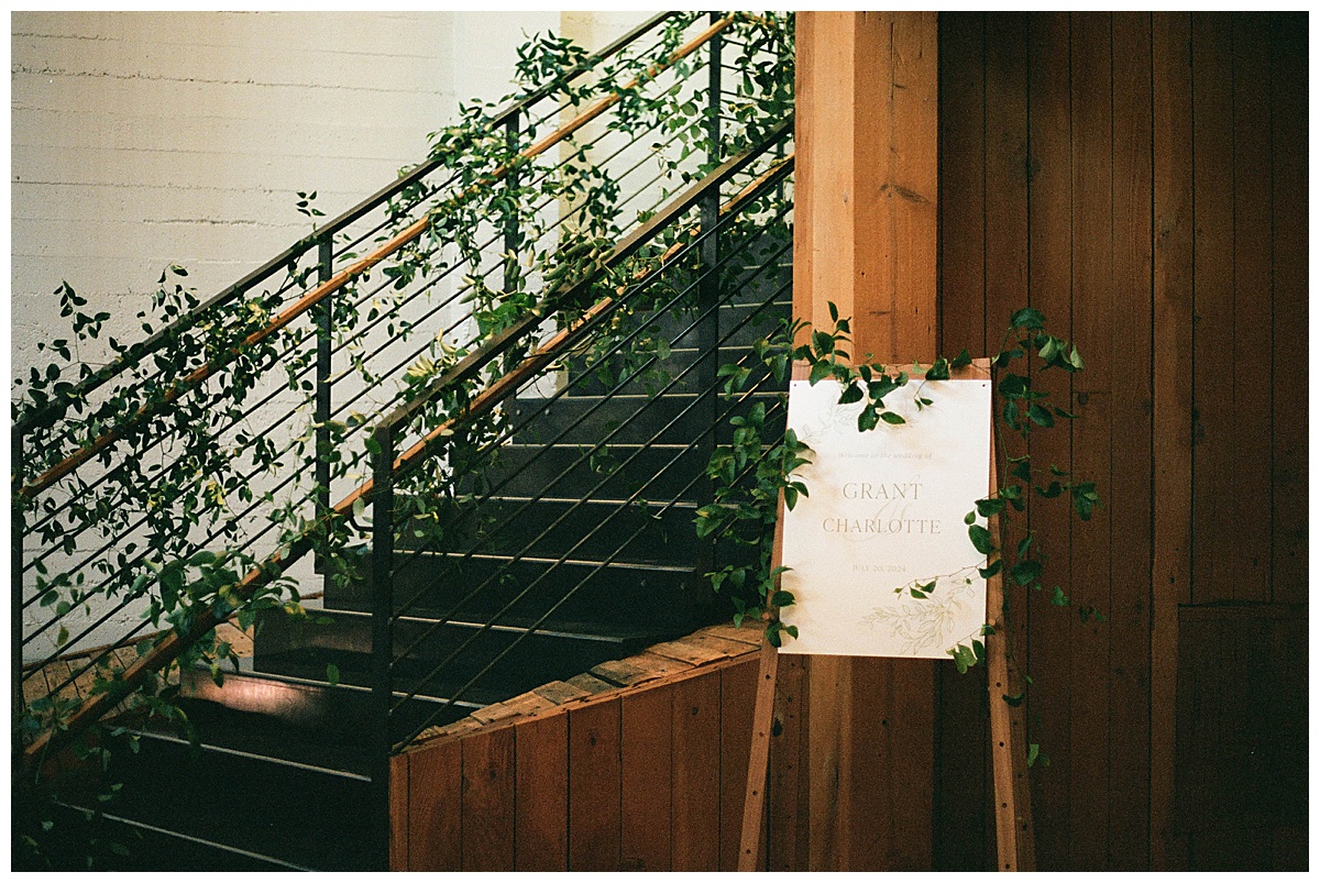 Staircase decorated with greenery at Charlotte and Grant’s wedding at Block41.