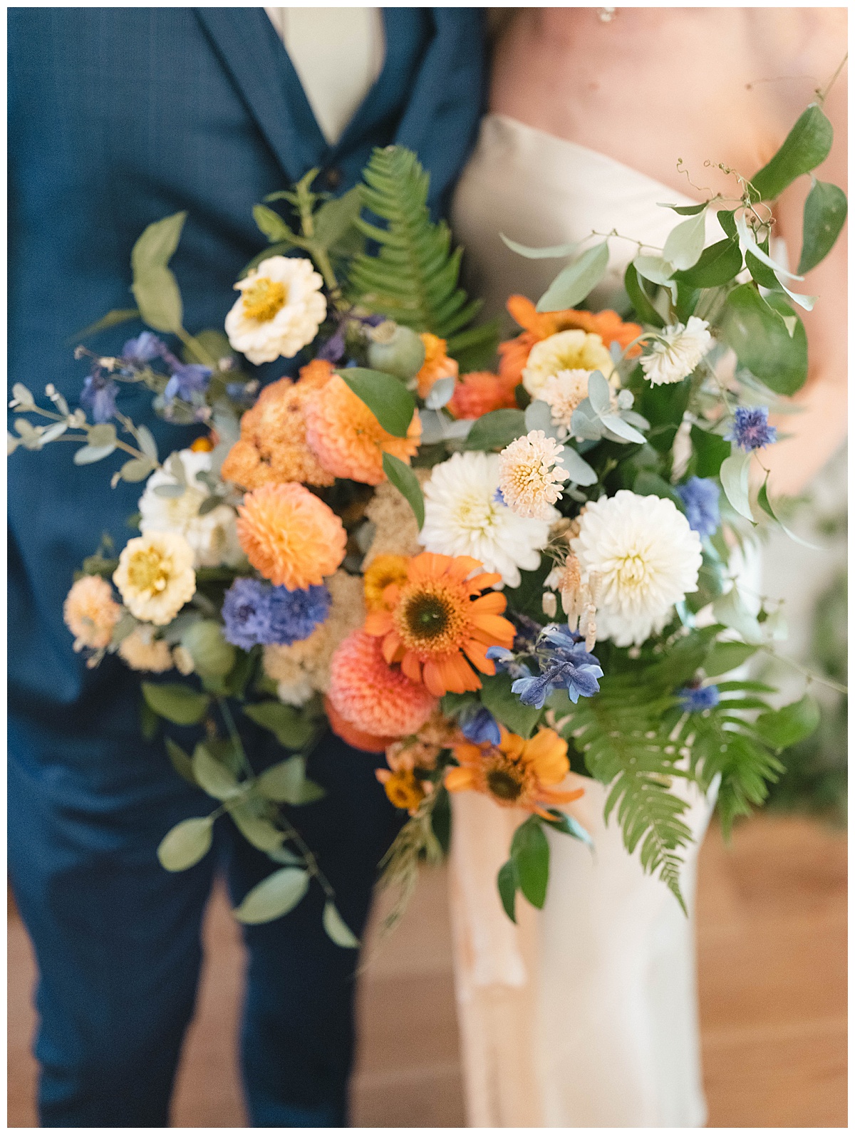 Charlotte’s vibrant bouquet of colorful flowers and greenery held before the wedding ceremony.