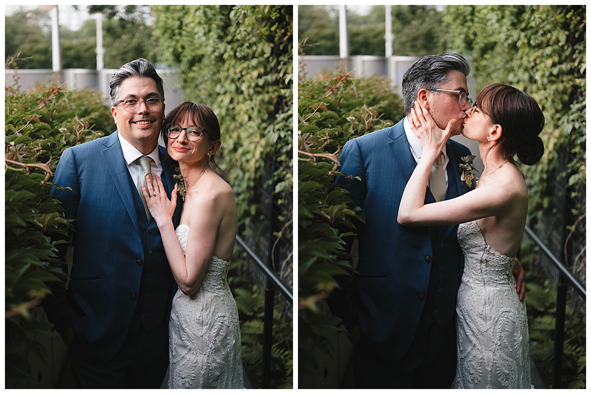 The couple shares a joyful kiss as they embrace surrounded by greenery.