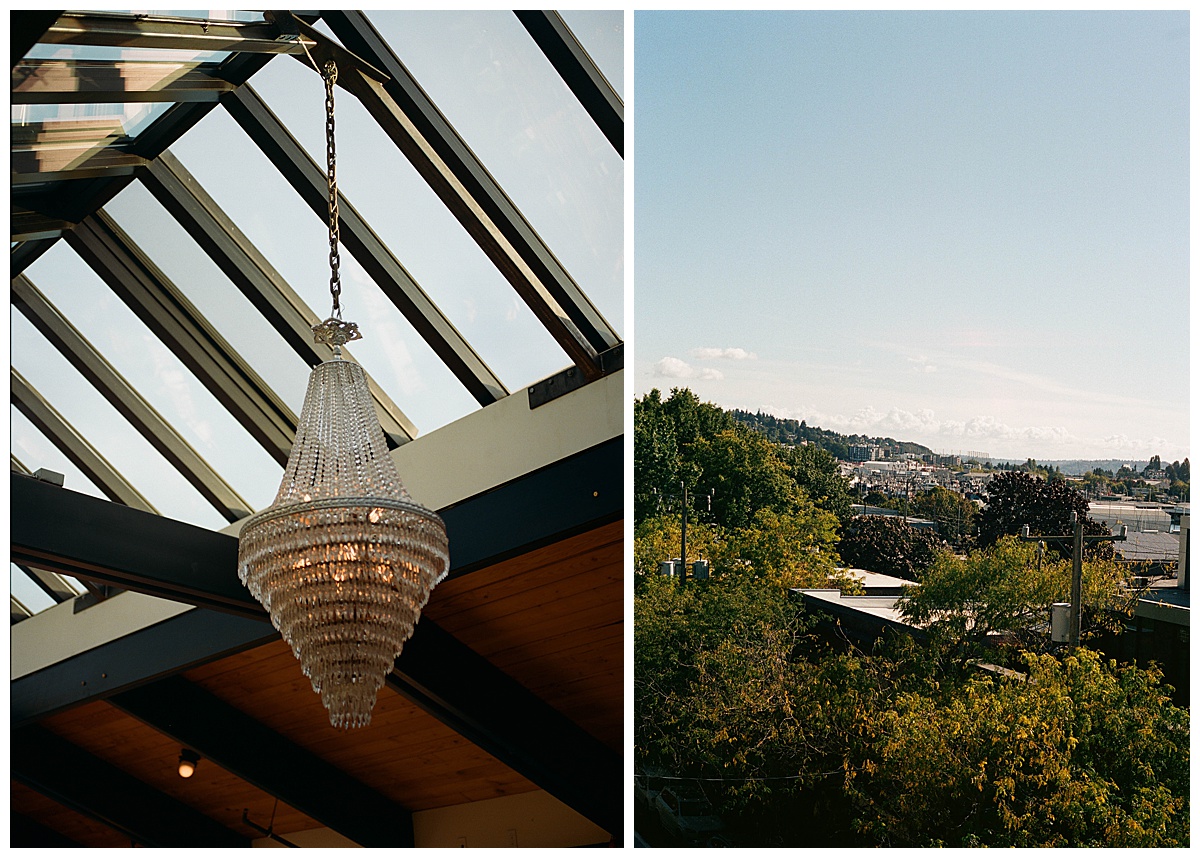 Crystal chandelier under a glass ceiling paired with a scenic rooftop view of Ballard and the surrounding landscape.