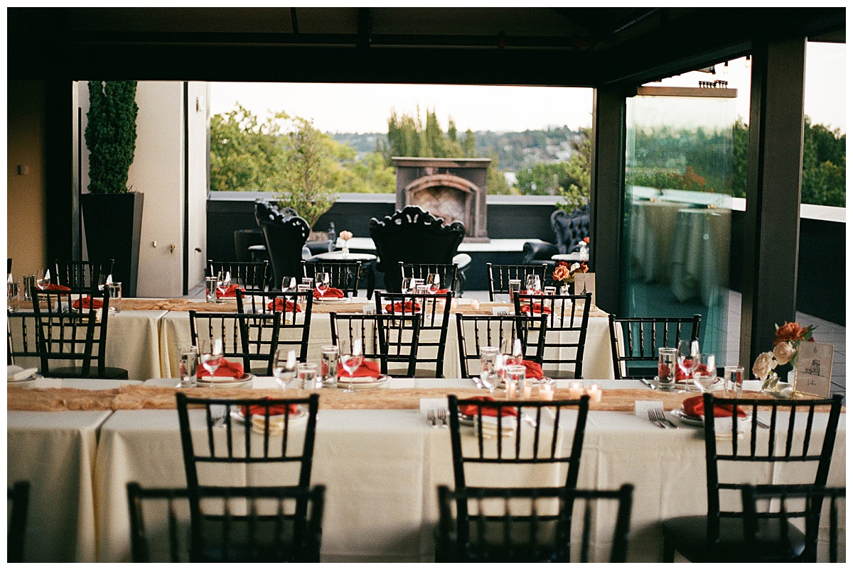 Reception tables arranged with elegant details, overlooking rooftop views at the Olympic Rooftop Pavilion.